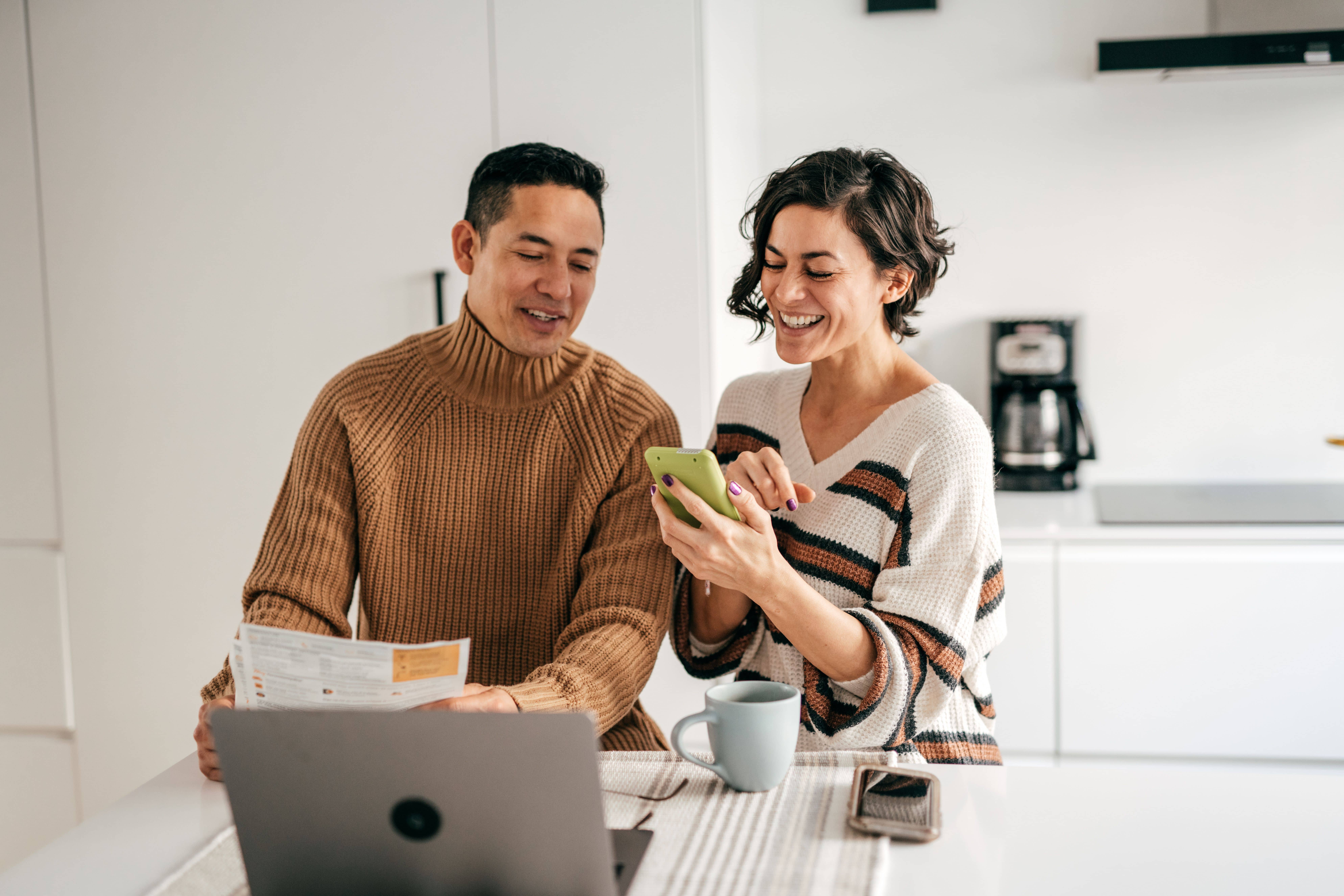 63e664b324379672e28fd47f_Man-and-woman-look-at-finances-on-phone