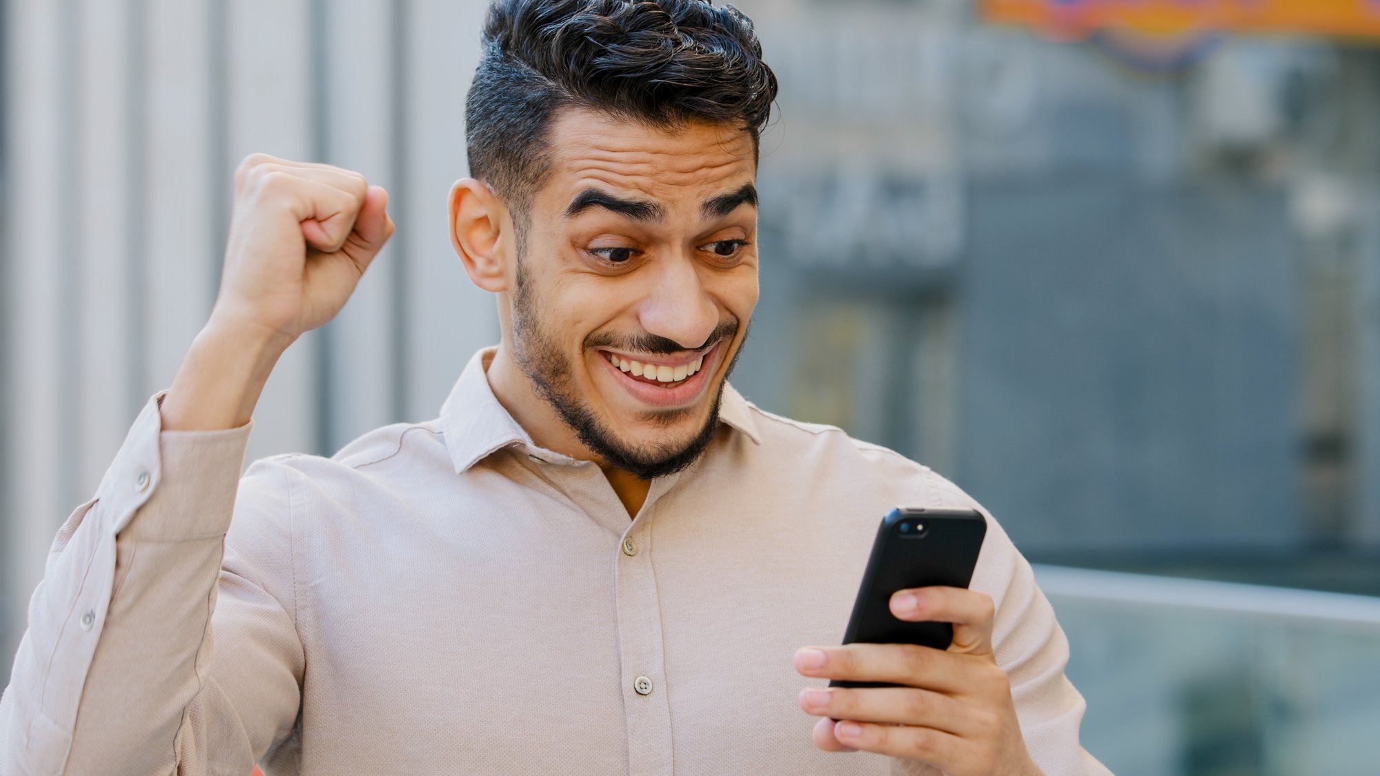 hispanic-amazed-businessman-receiving-sms-message-2022-10-01-04-50-03-utc